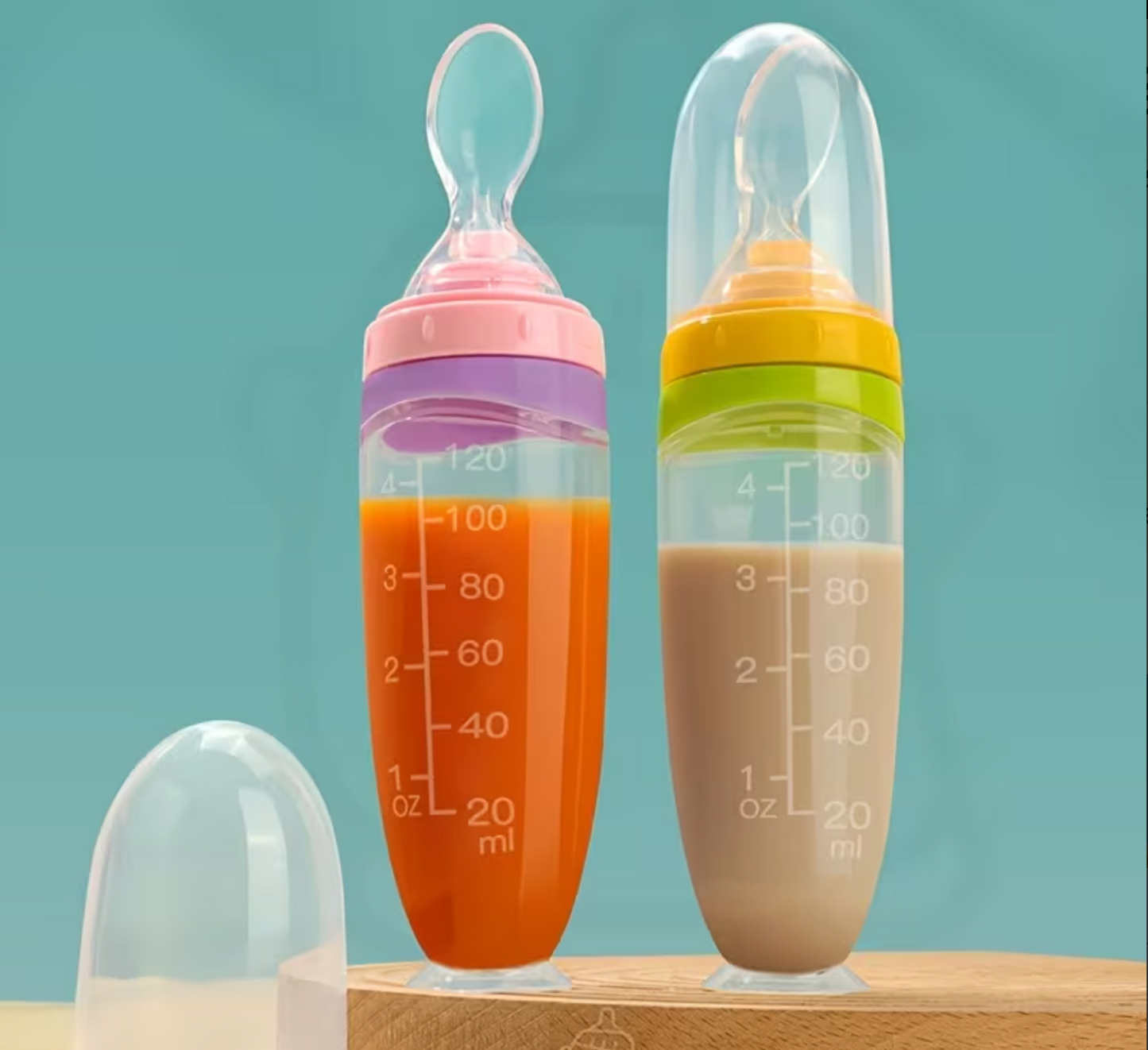 AWE™ Squeeze Spoon Feeder in pink and yellow variants